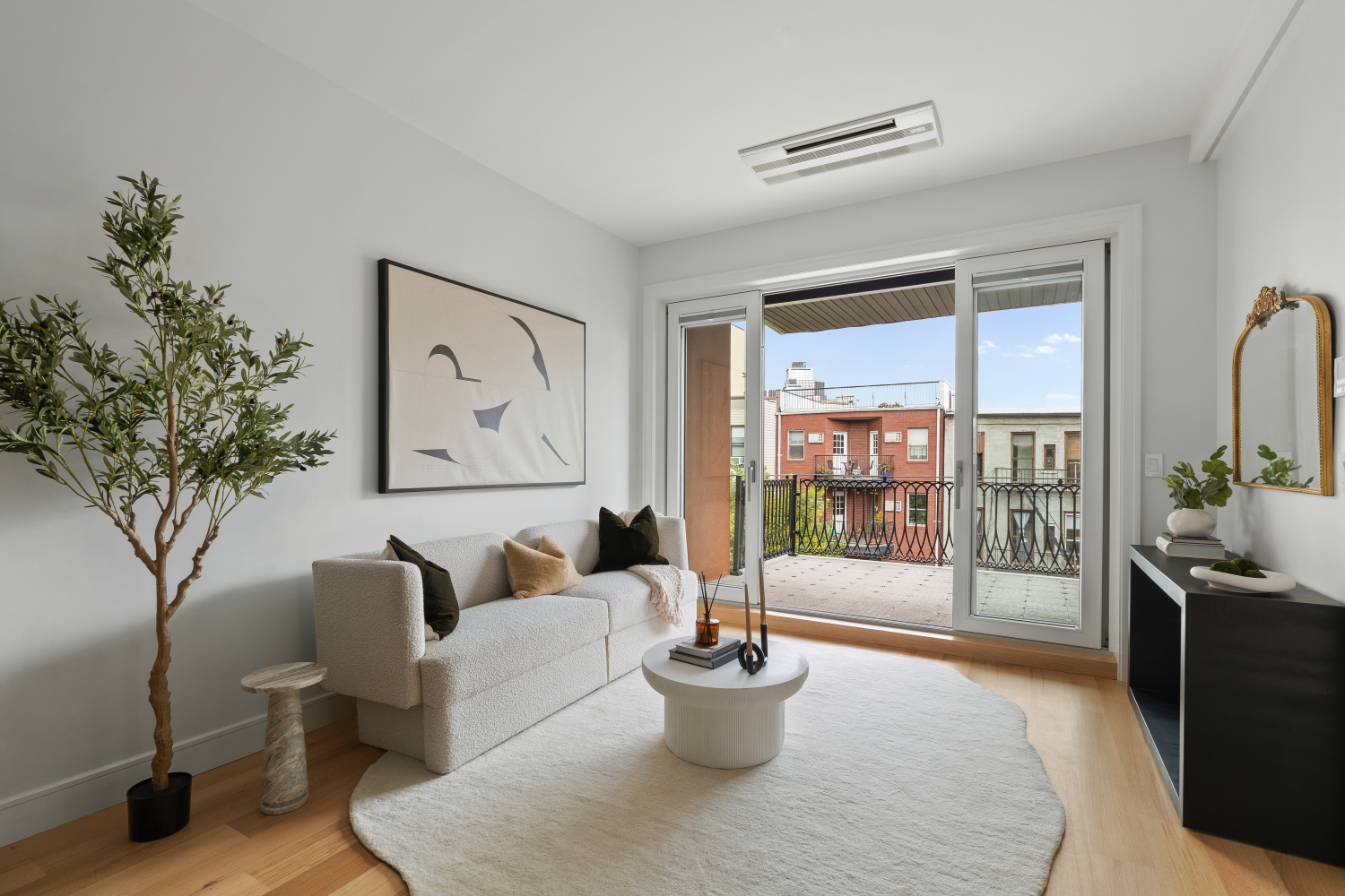 a living room with furniture and a potted plant