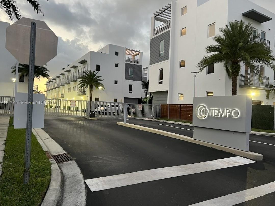 a view of a street with seating area and car parked