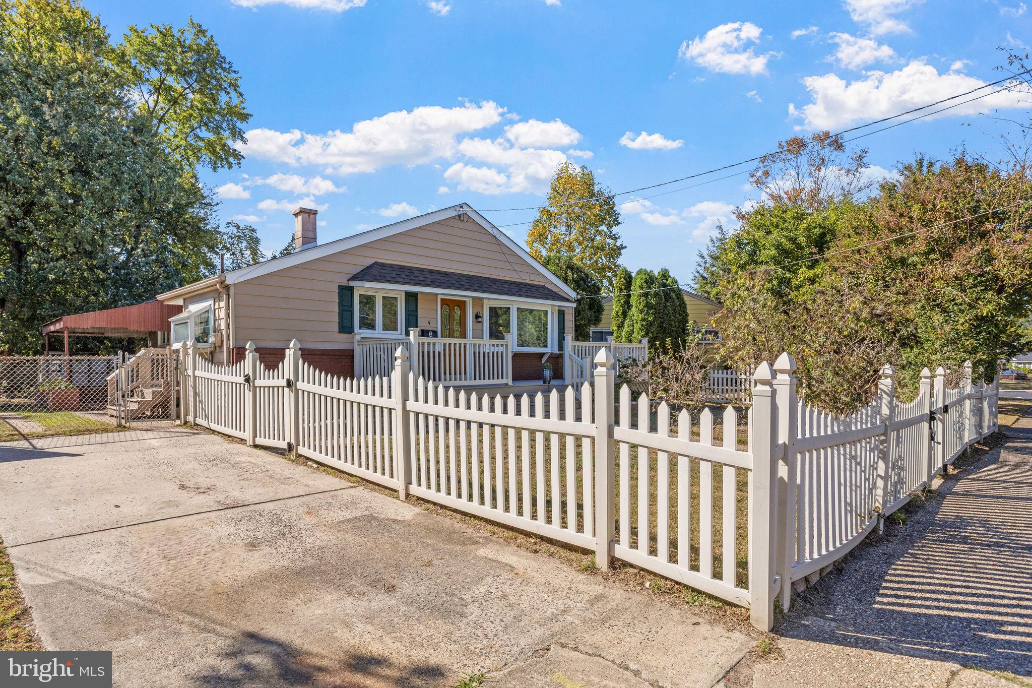 a view of a house with wooden fence