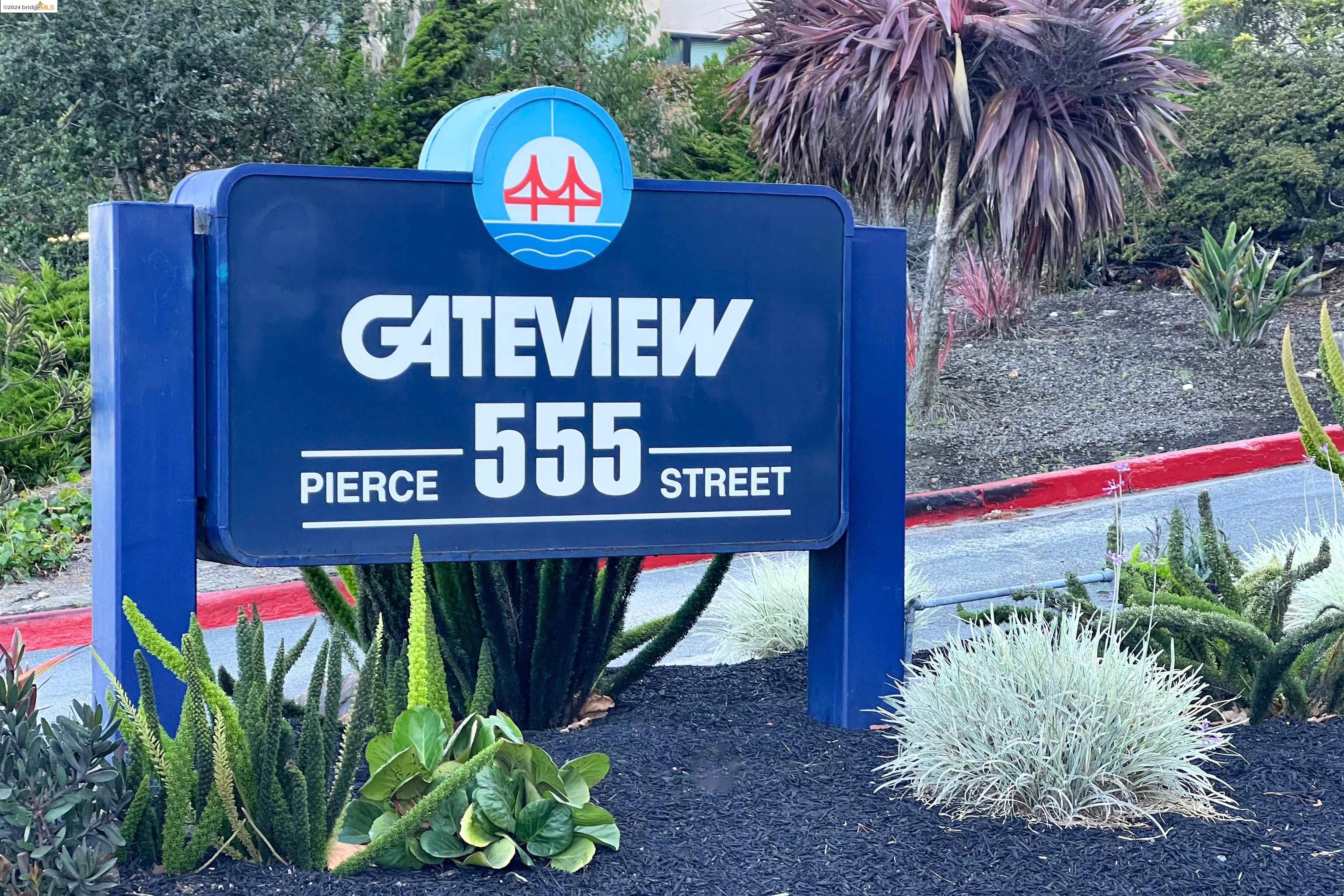 a view of sign board with potted plants