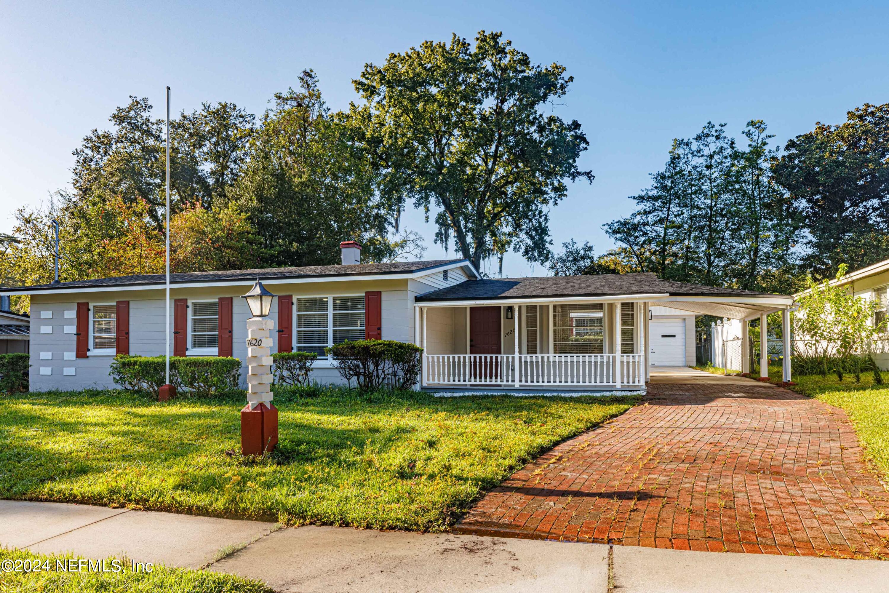 a front view of house with yard and trees around