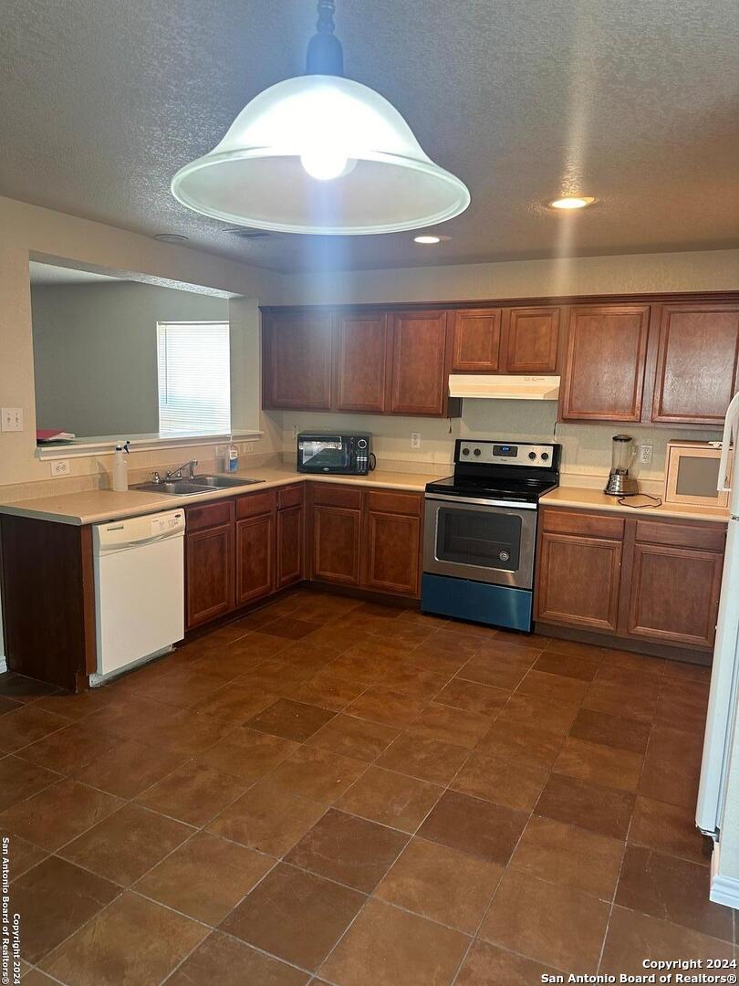 a large kitchen with cabinets and stainless steel appliances