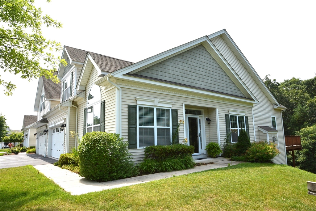 a view of a house with a yard and plants