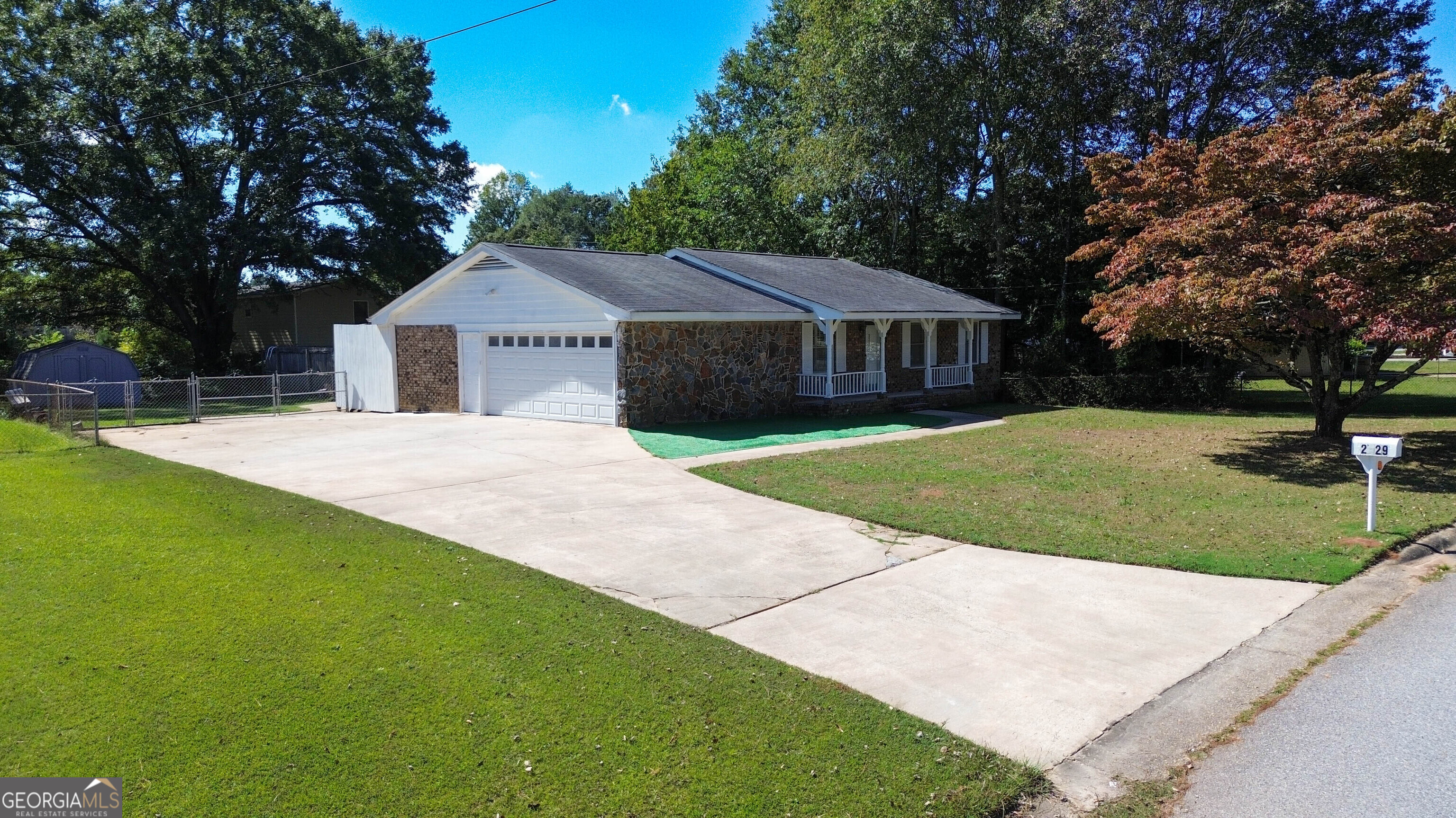 a front view of house with yard and green space