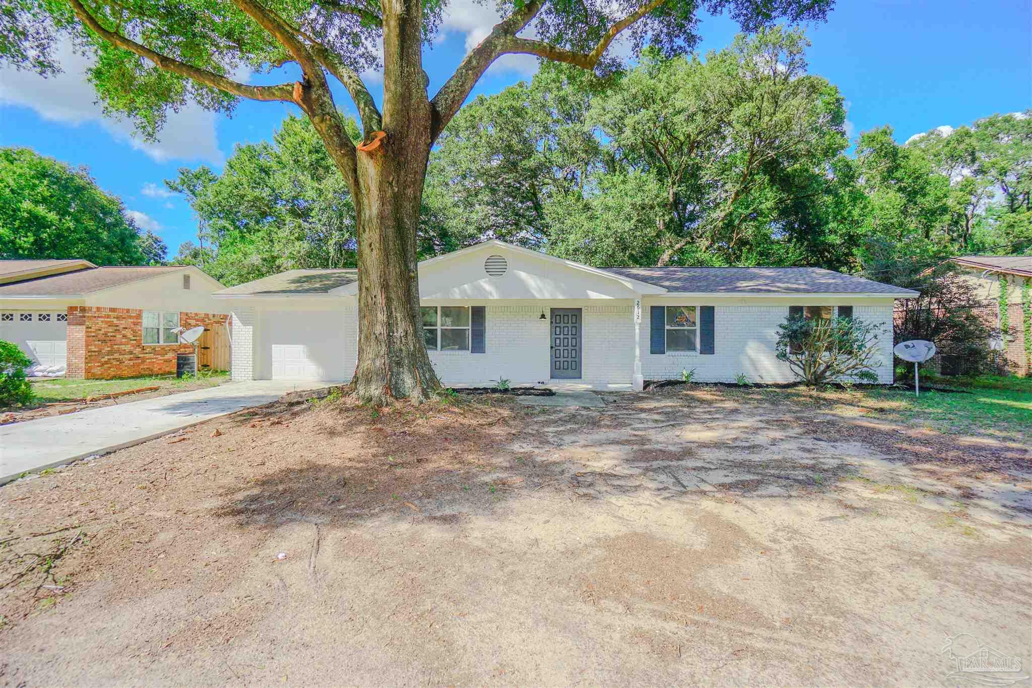 front view of a house with a trees