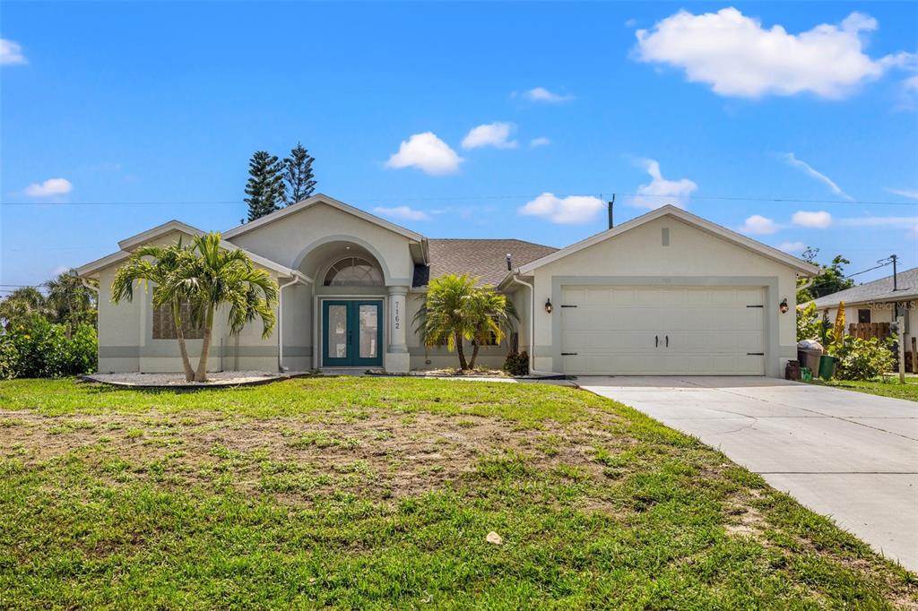 a view of a house with a yard and garage