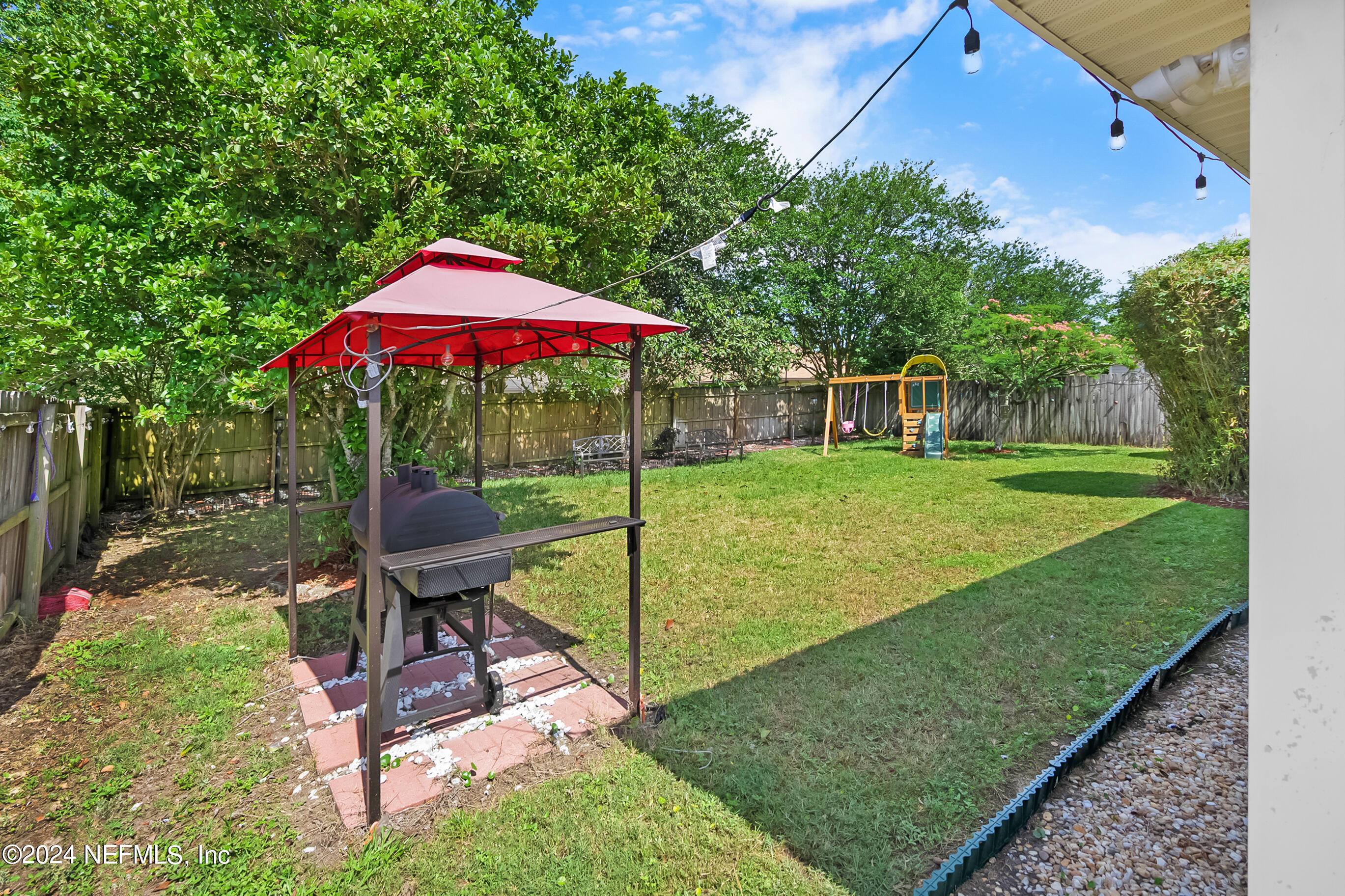 a view of a backyard with sitting area and furniture