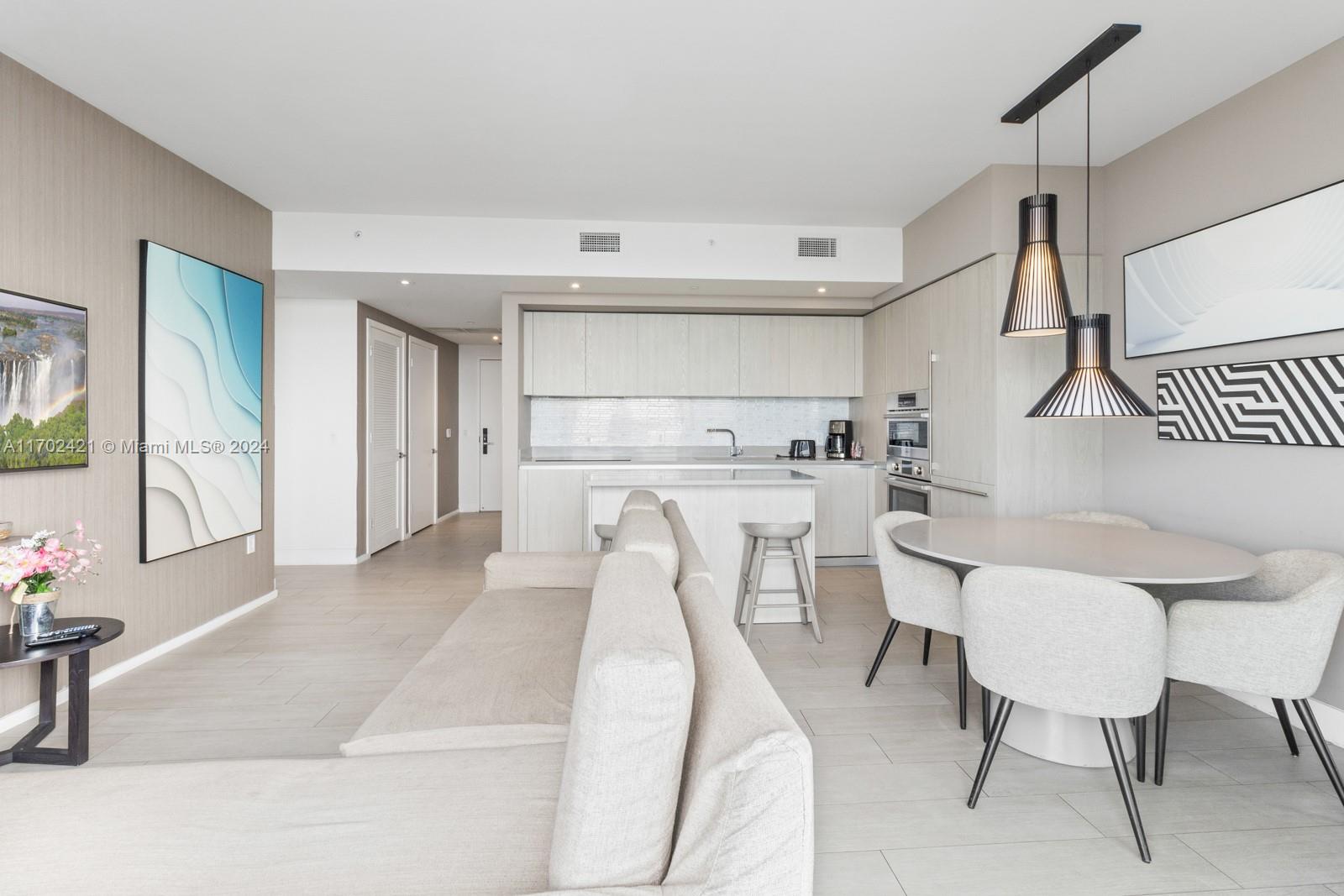 a living room with furniture a table and chairs