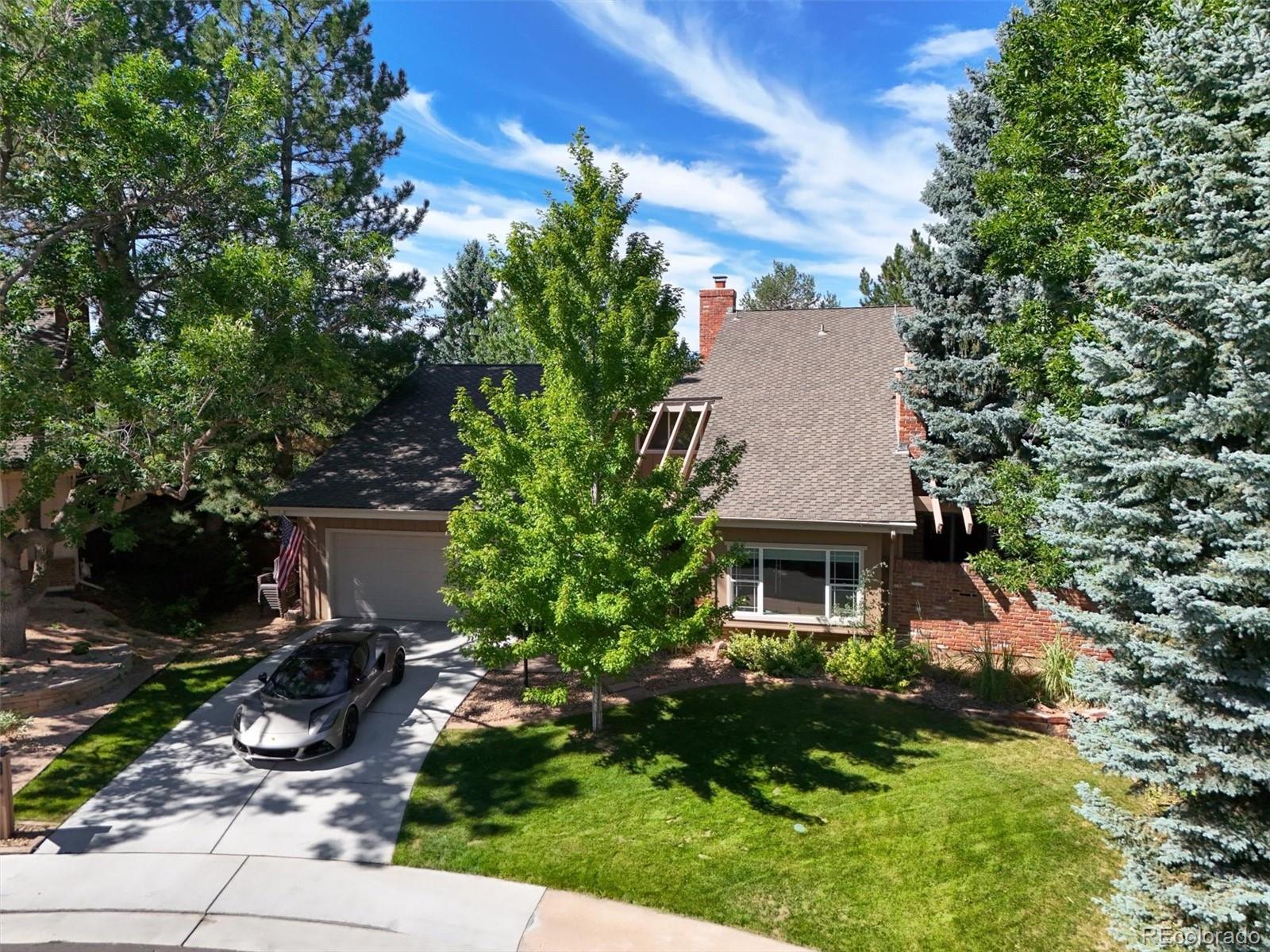 a aerial view of a house with yard and green space