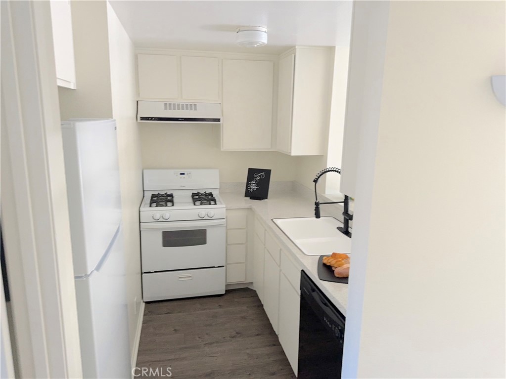 a utility room with sink dryer and washer