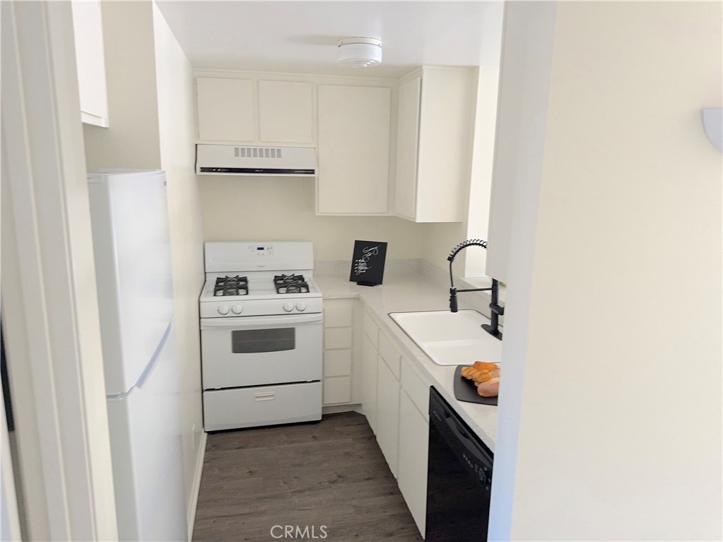 a utility room with sink dryer and washer