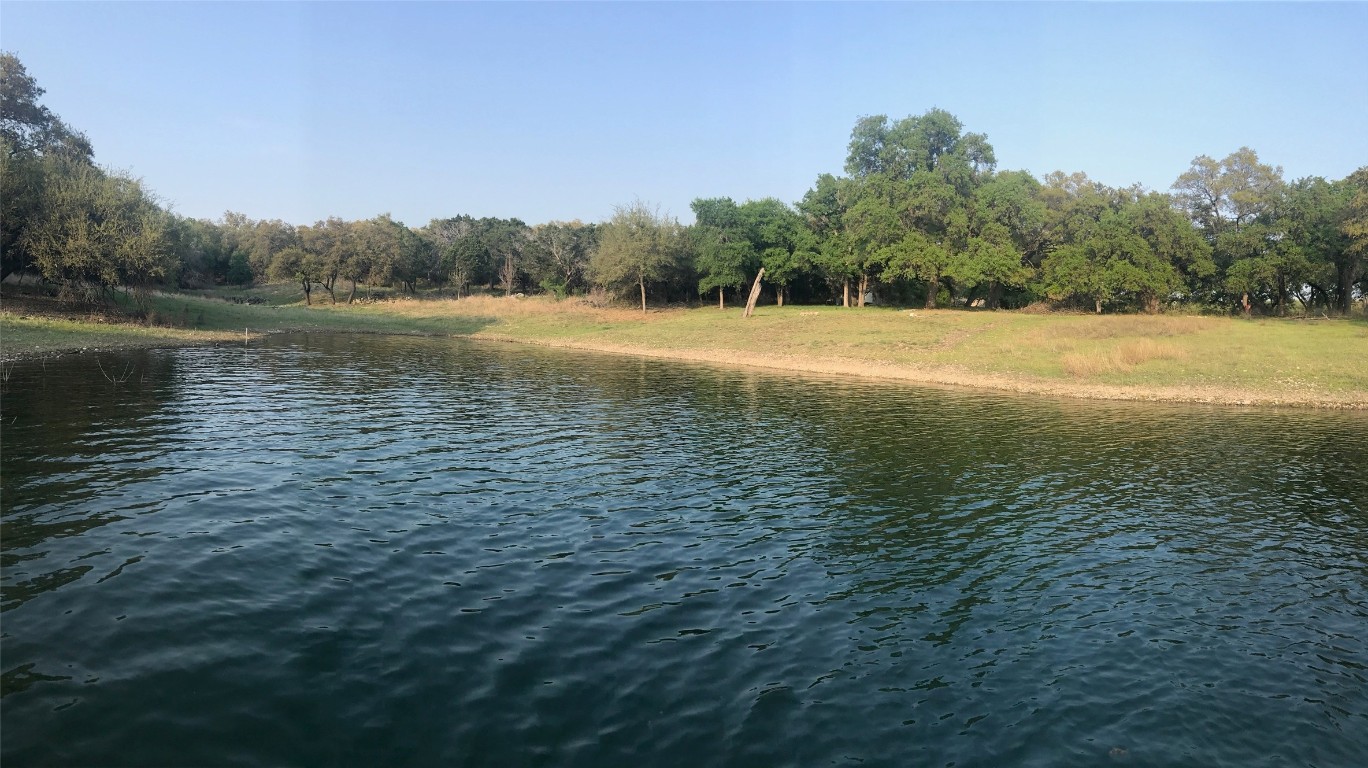 a view of lake with green field