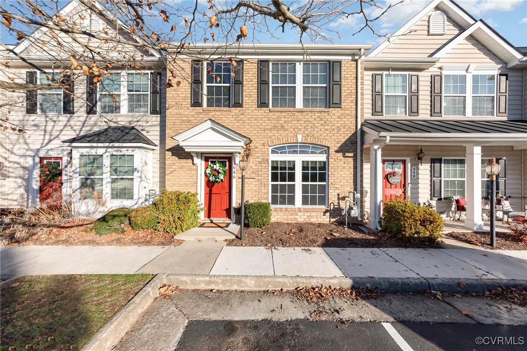 Front view of Brick front townhome with assigned p