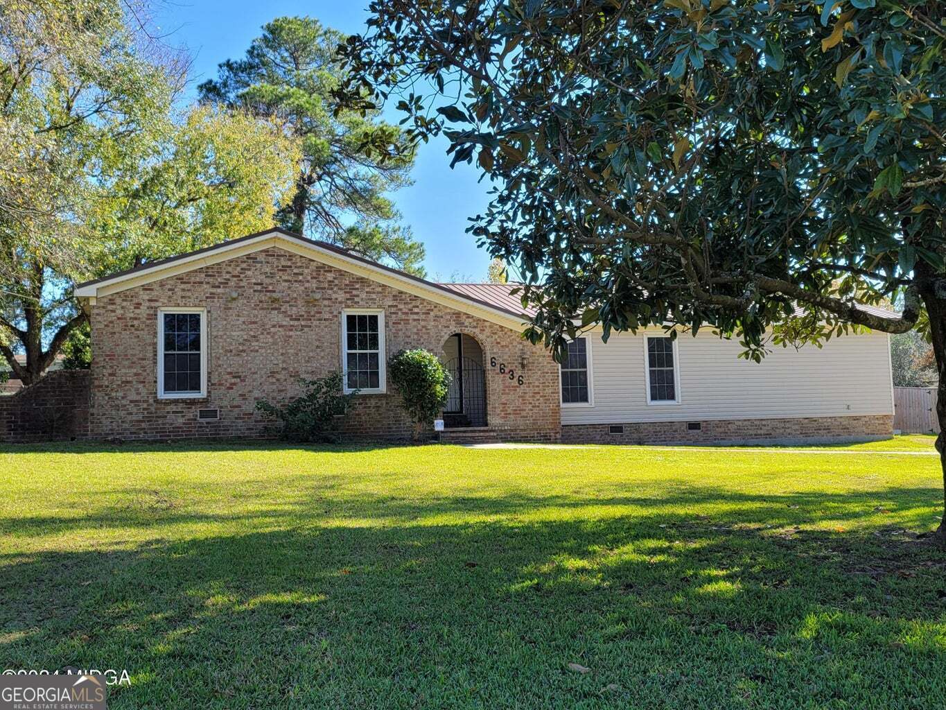 a view of a house with swimming pool and a yard