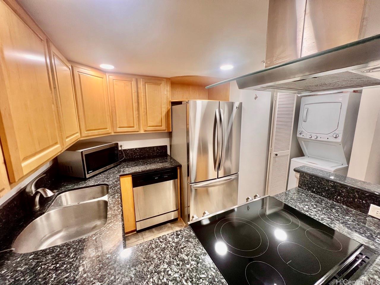 a kitchen with granite countertop a refrigerator and a stove