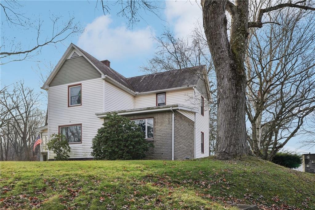 a house with a yard and a large tree