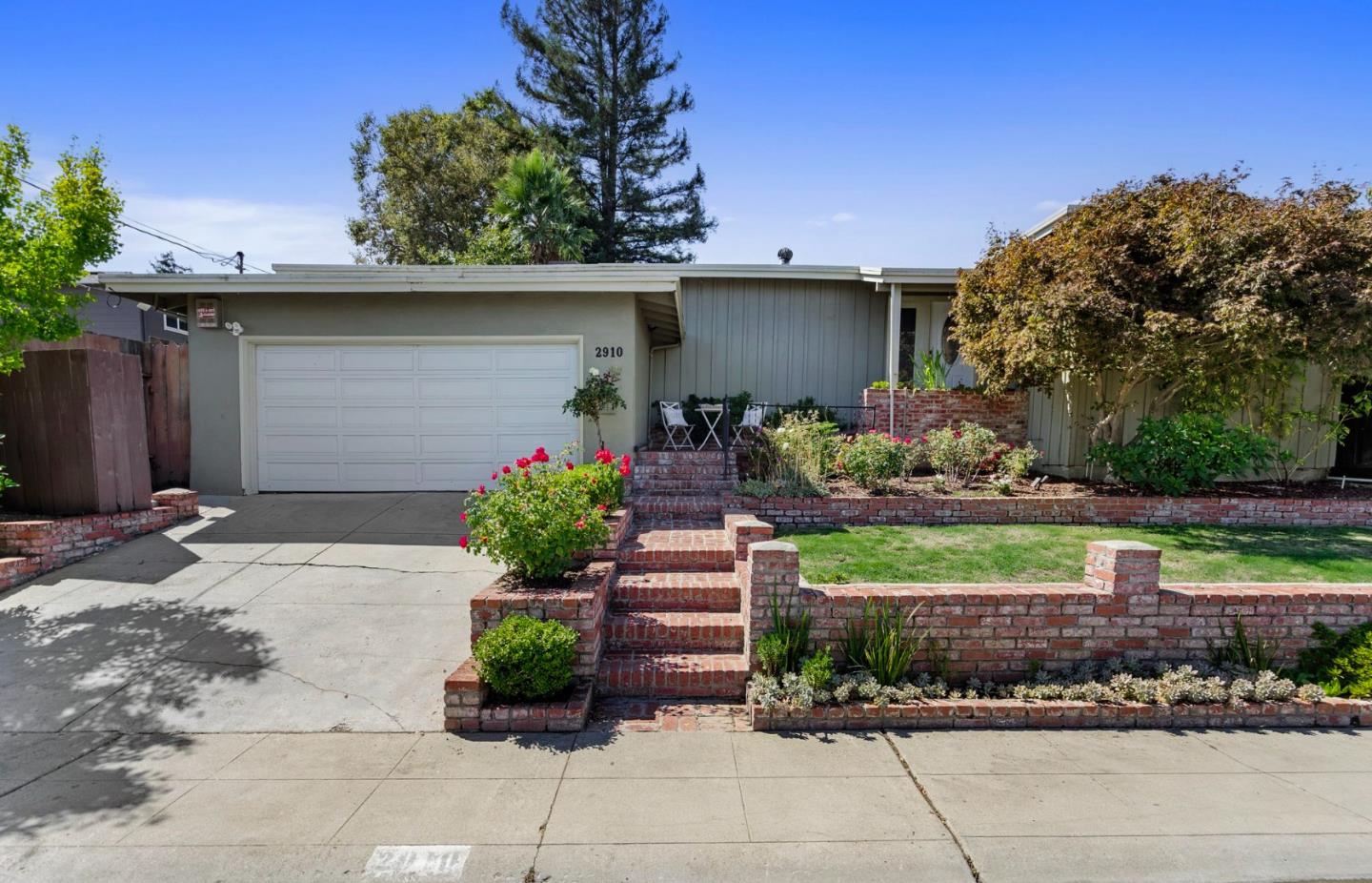 a front view of a house with garden