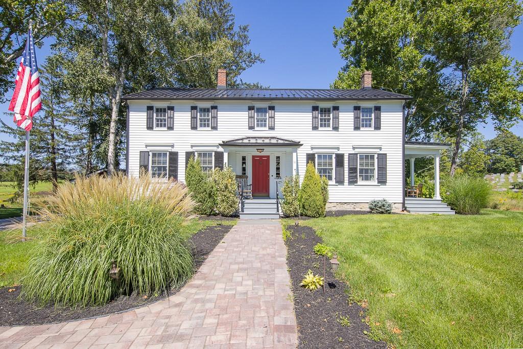 a front view of a house with a garden