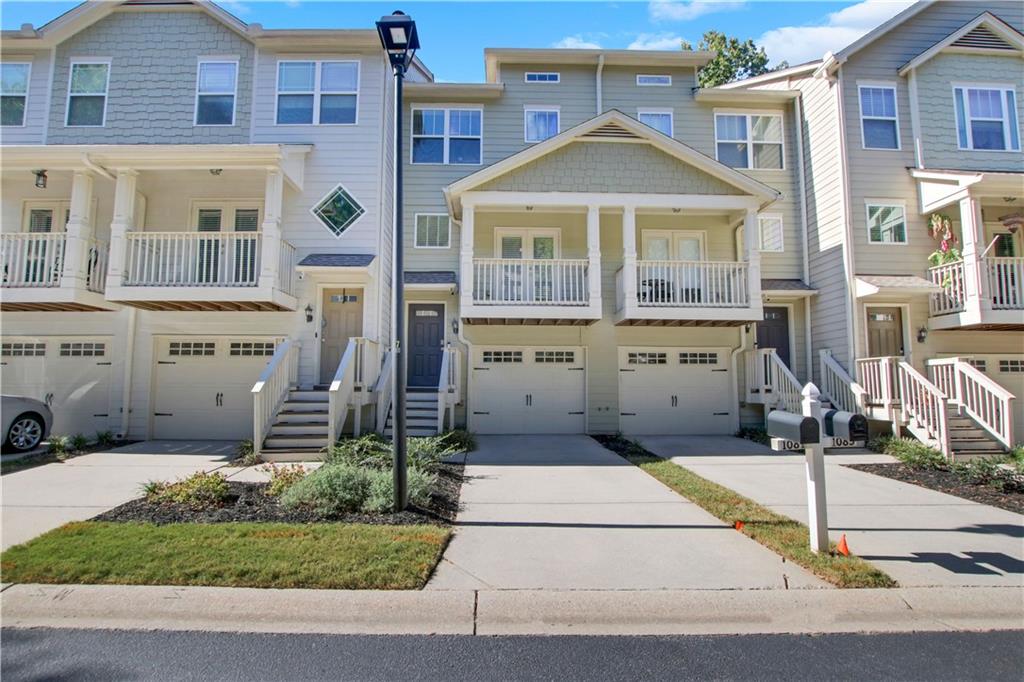 a front view of a residential apartment building with a yard