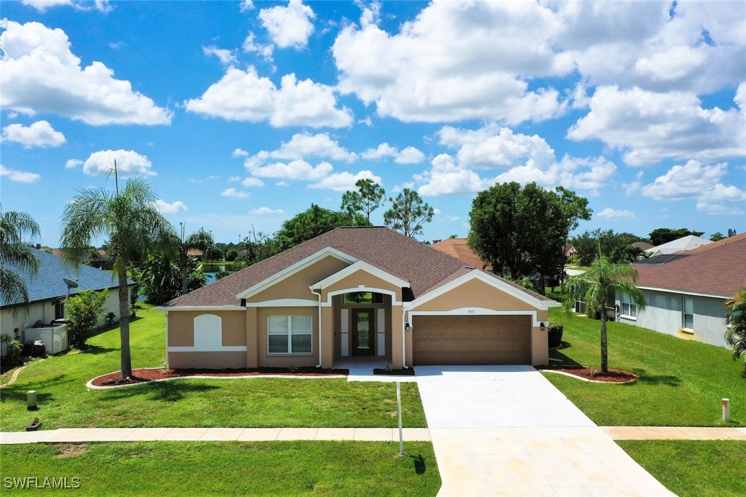 a front view of house with yard and green space