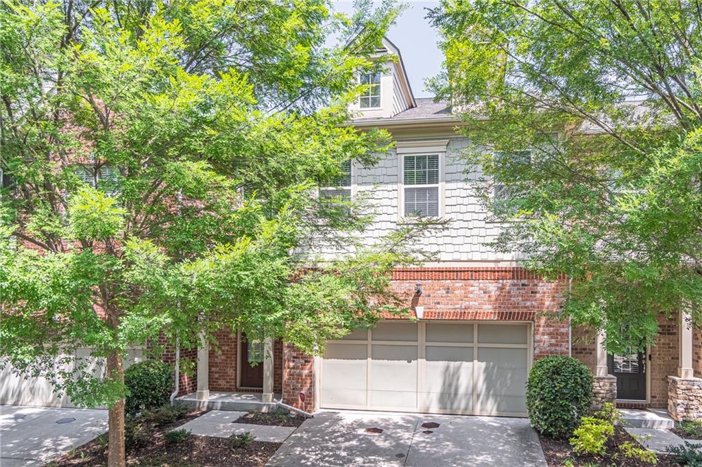 a view of a brick house with a tree