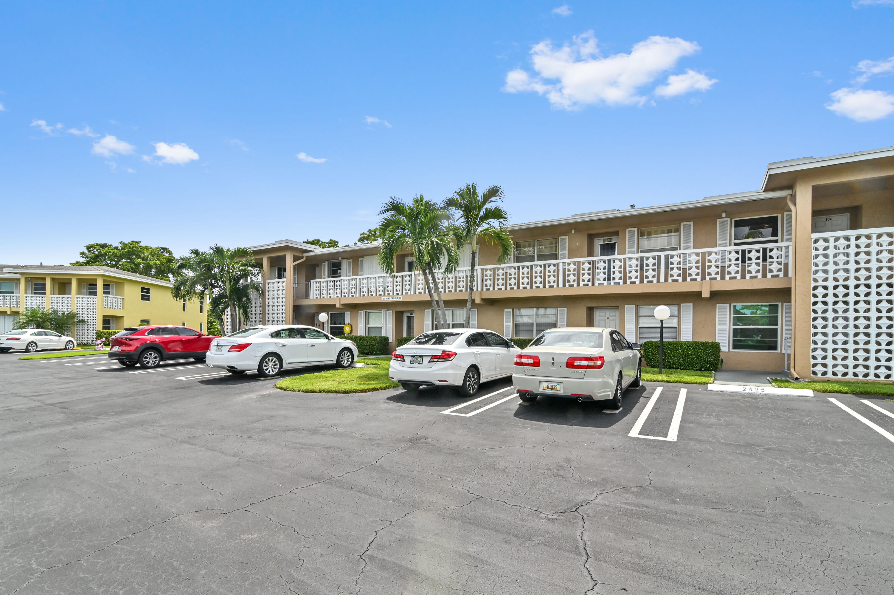 a view of a cars park in front of a building