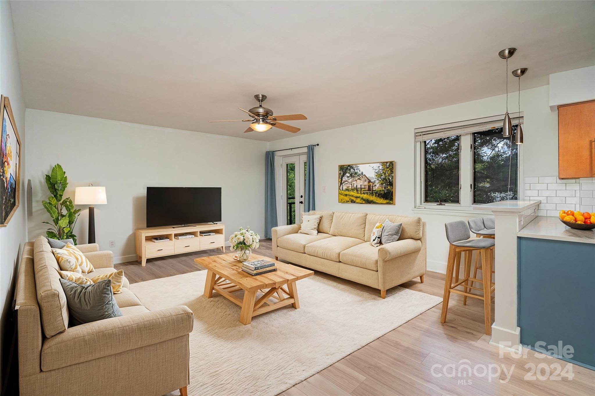 a living room with furniture and a flat screen tv