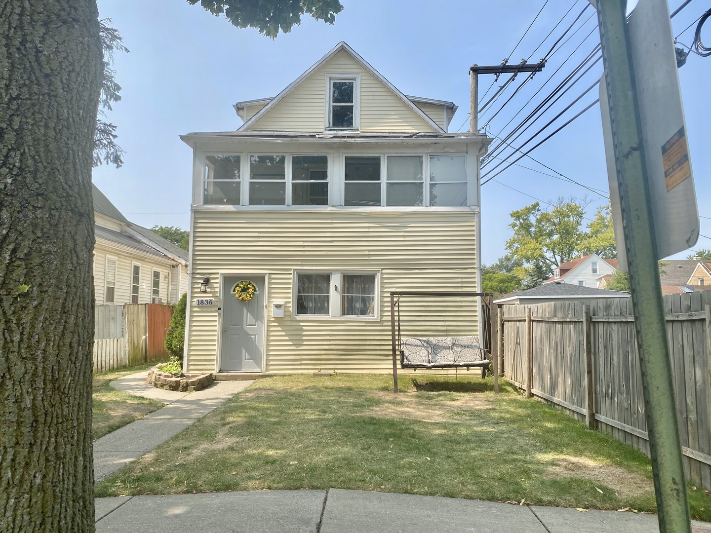 a view of a house with backyard and wooden fence