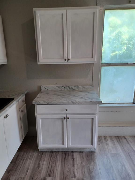 a view of cabinets and wooden floor