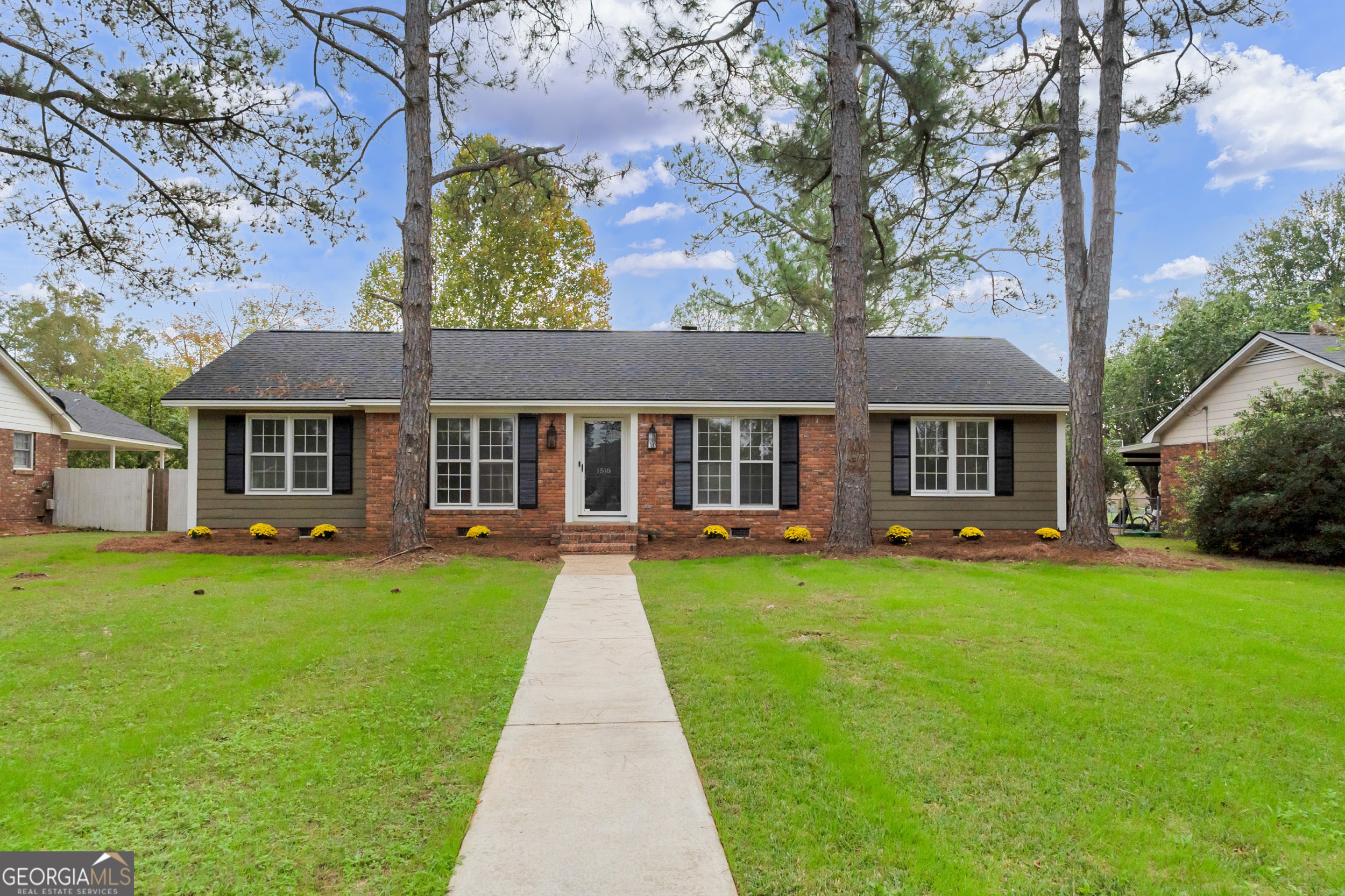 a front view of a house with yard patio and green space