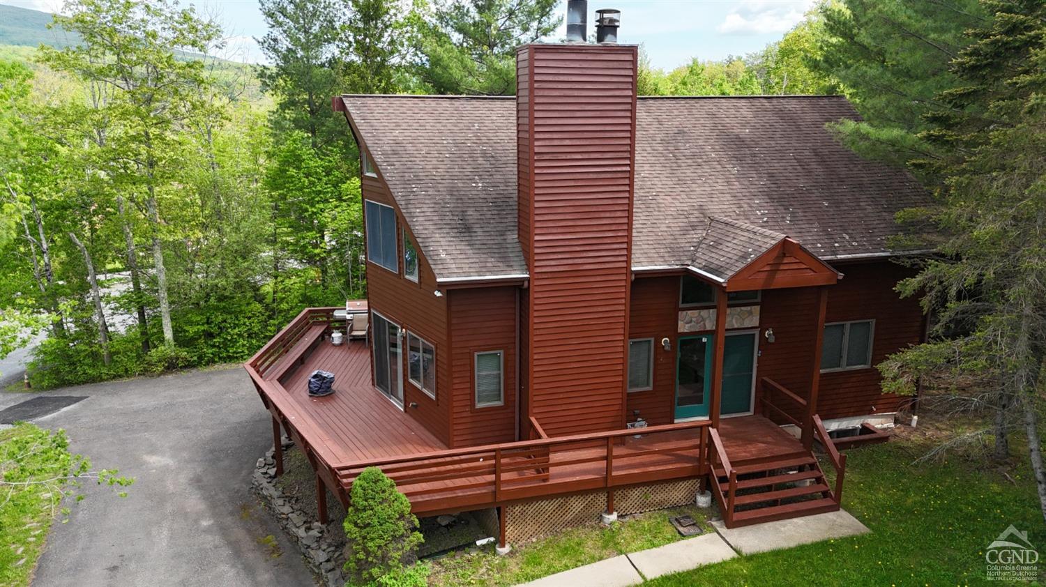 a aerial view of a house with a yard and furniture