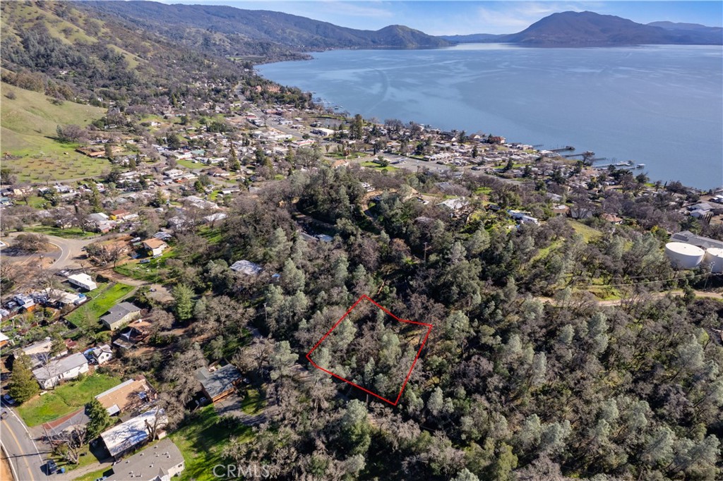 an aerial view of house with yard and mountain view in back