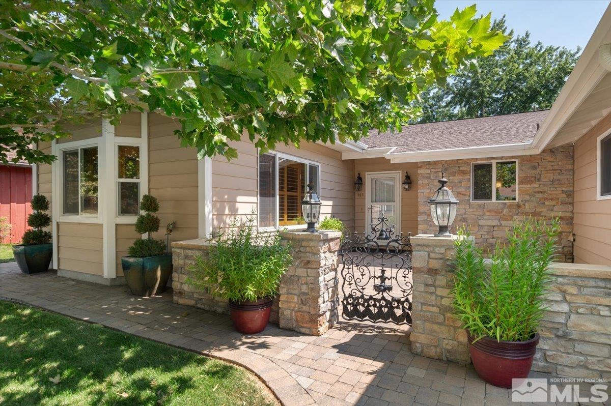 a front view of a house with a garden