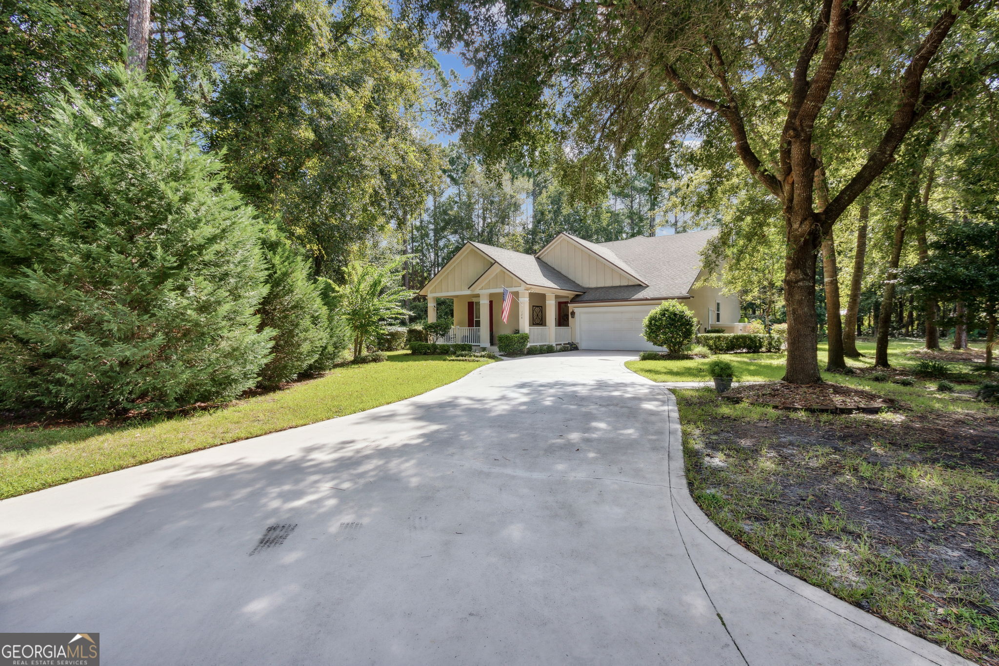 a front view of a house with a yard and trees