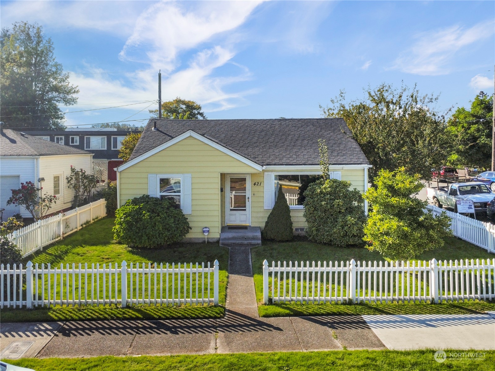 a front view of a house with a garden