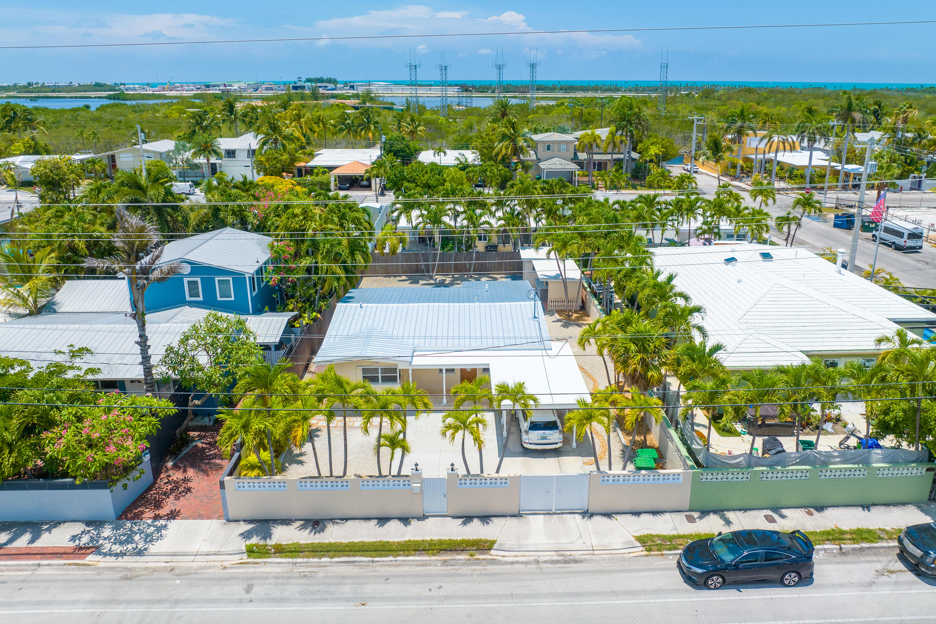 an aerial view of residential houses with outdoor space and parking