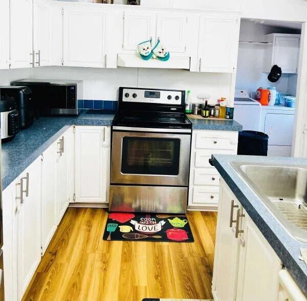 a kitchen with stainless steel appliances granite countertop a sink and a stove