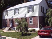 a view of a house with a yard and sitting space