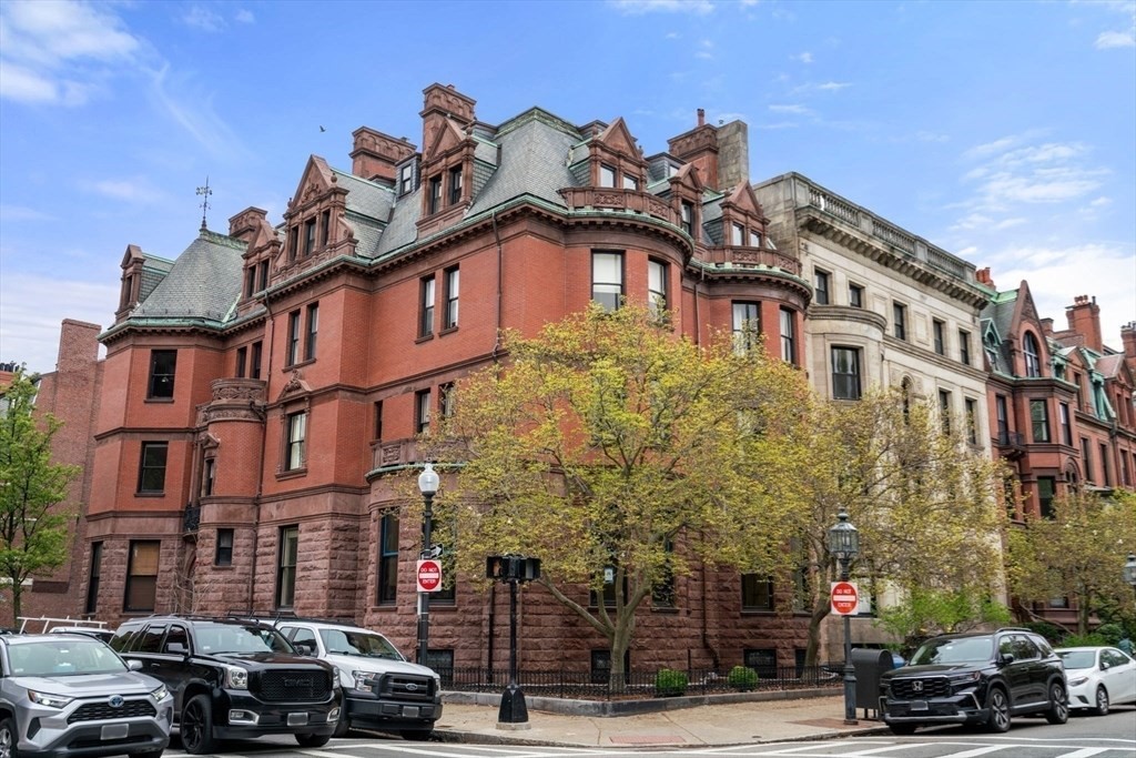 a front view of a building and car parked