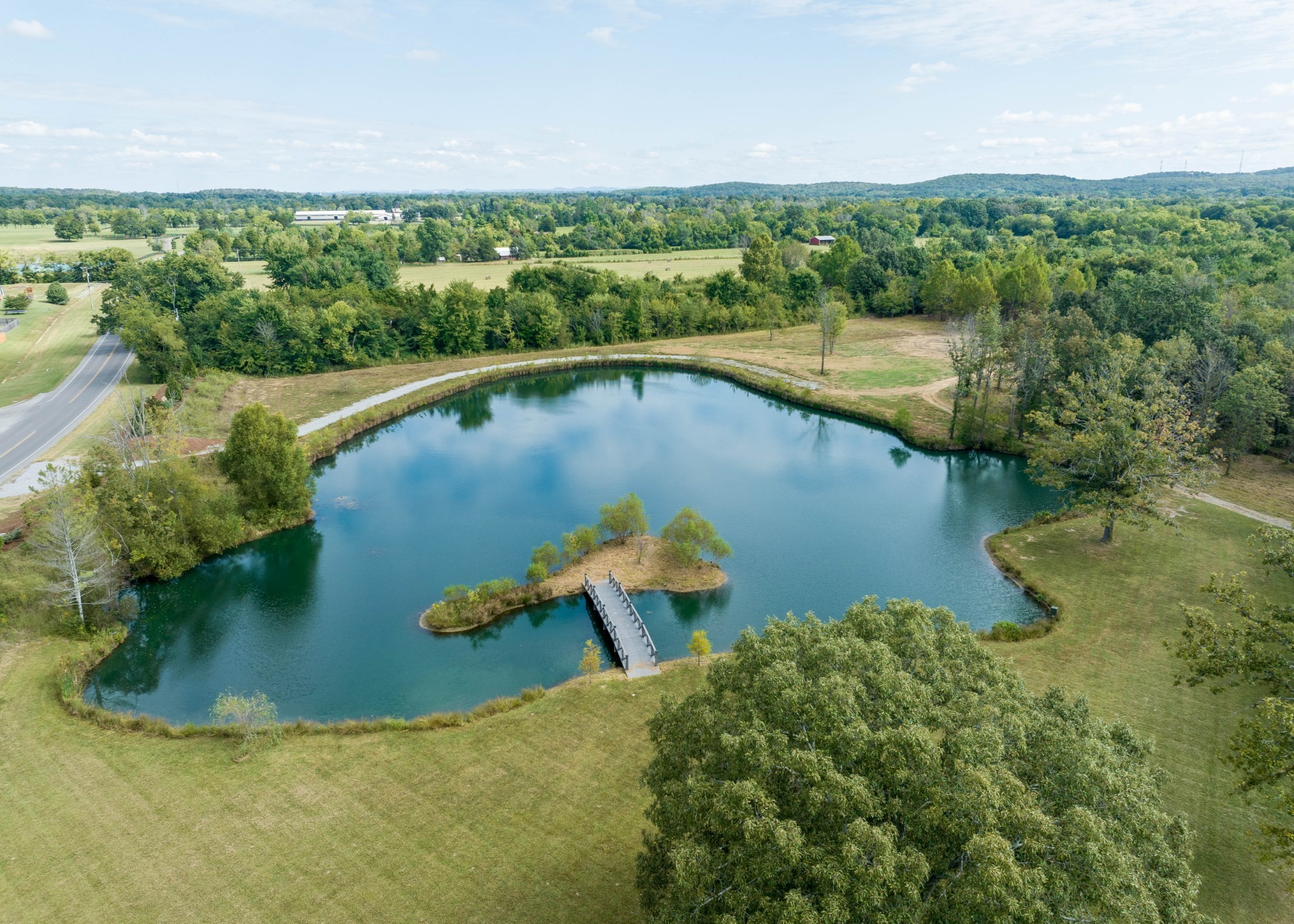 an aerial view of a house with a yard and lake view