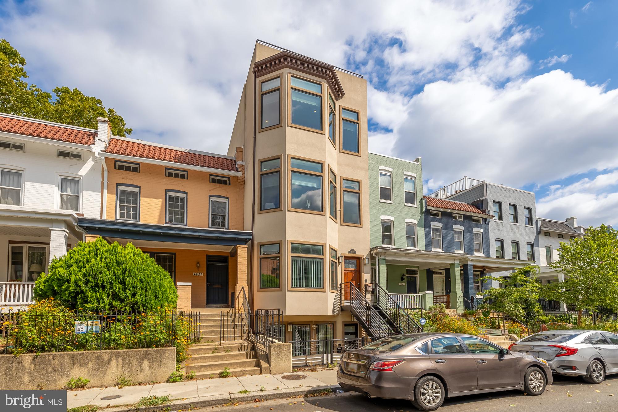 a front view of a residential apartment building with a yard