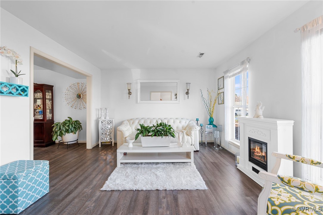 Living room with dark wood-type flooring