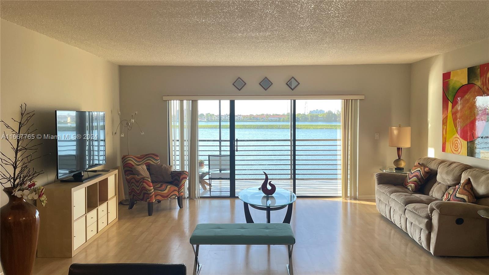 a living room with furniture and floor to ceiling windows