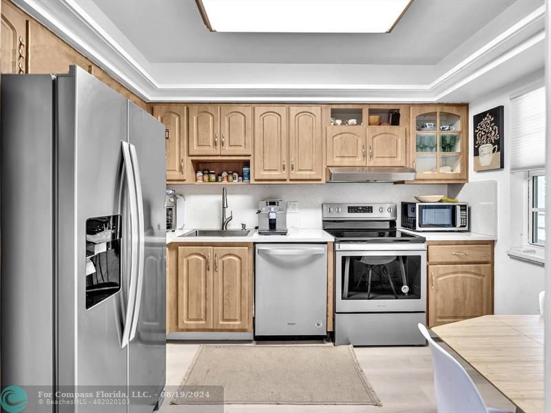 a kitchen with stainless steel appliances granite countertop a refrigerator sink and cabinets