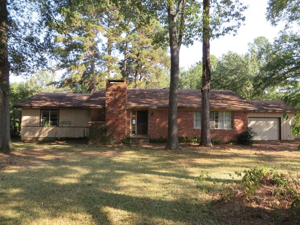 a view of a house with a large tree