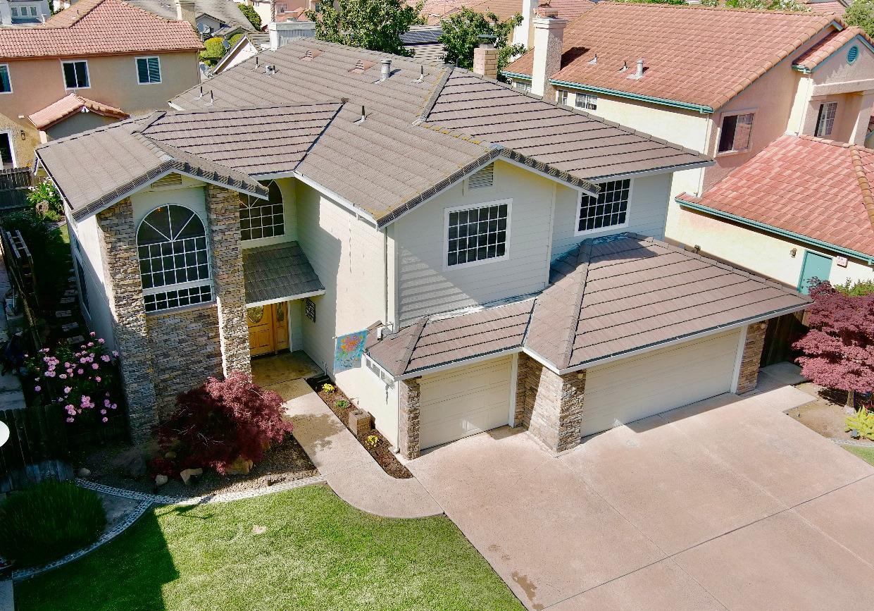 a aerial view of a house with a yard and potted plants