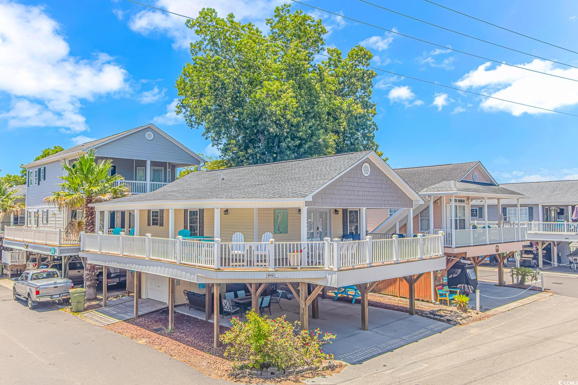 Rear view of property with a porch, a garage, and