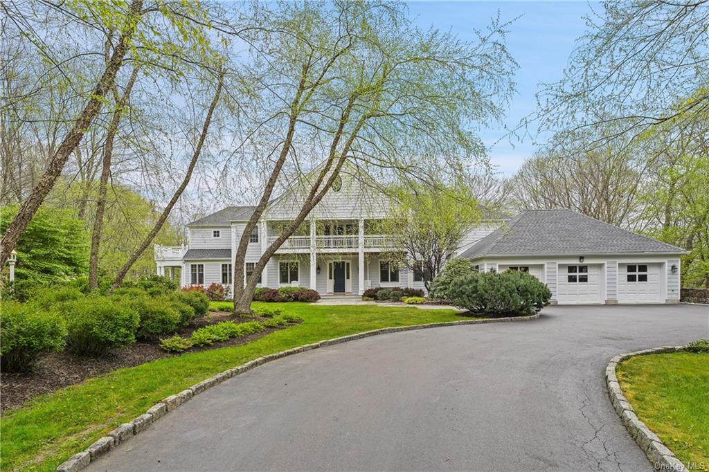 a front view of a house with a yard and trees