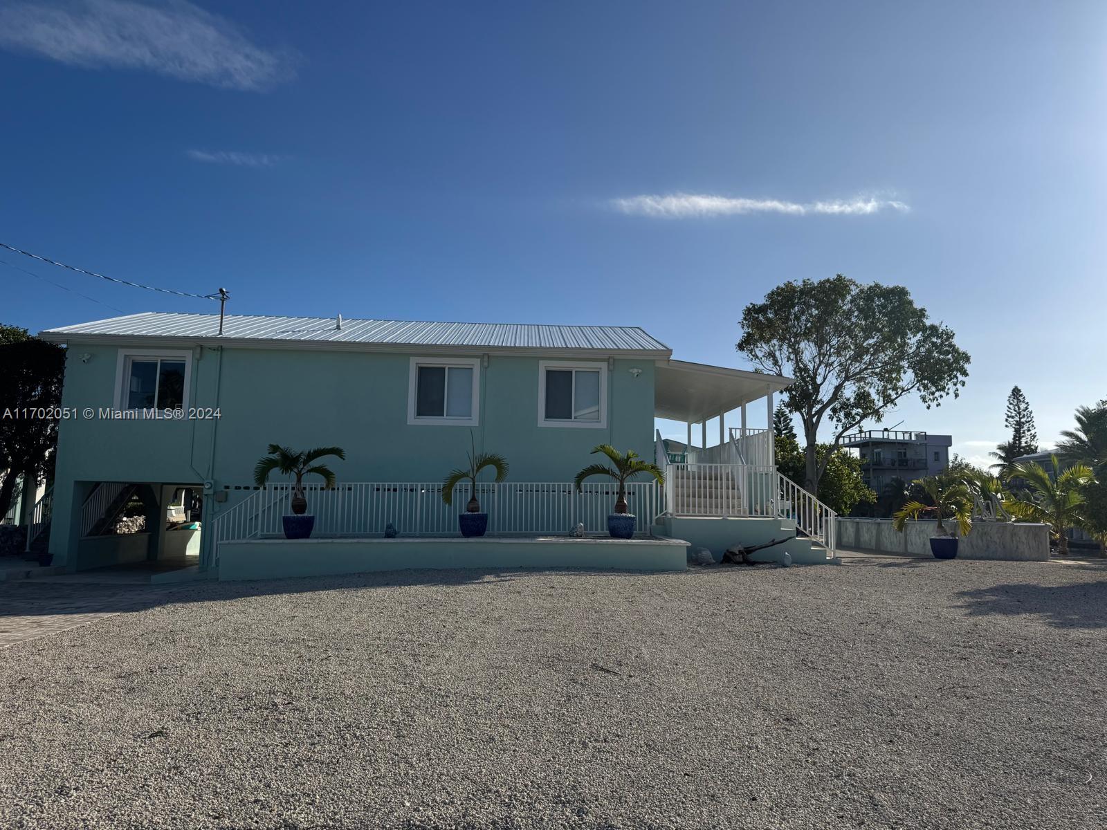 a front view of a house with a yard and a garage