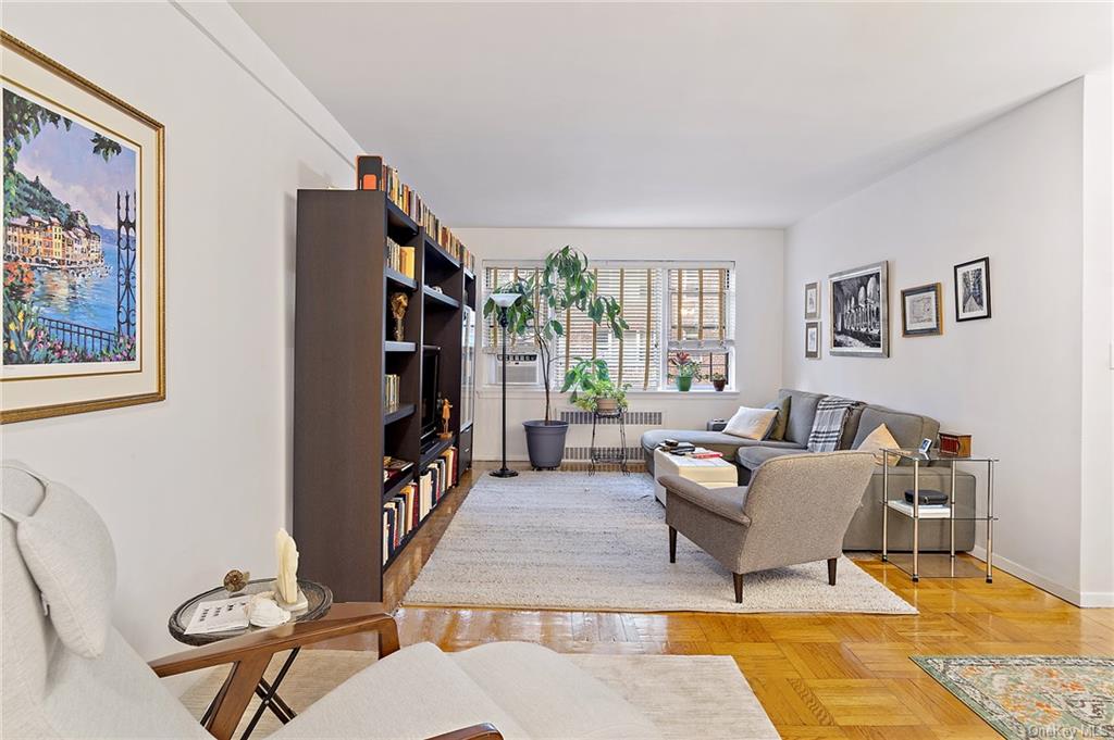 a living room with furniture a couch and a bookshelf